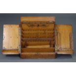 A Victorian oak large slope-front stationery cabinet with fitted interior enclosed by pair of