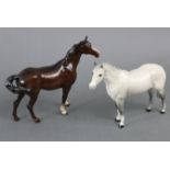 A Beswick model of a standing dapple-grey horse, 7¾” high; & a ditto model of a standing bay