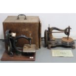 Two early 20th century sewing machines, each with case.