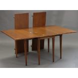 A hardwood drop-leaf dining table (with two additional leaves) on six square tapered legs, 46” x 96”