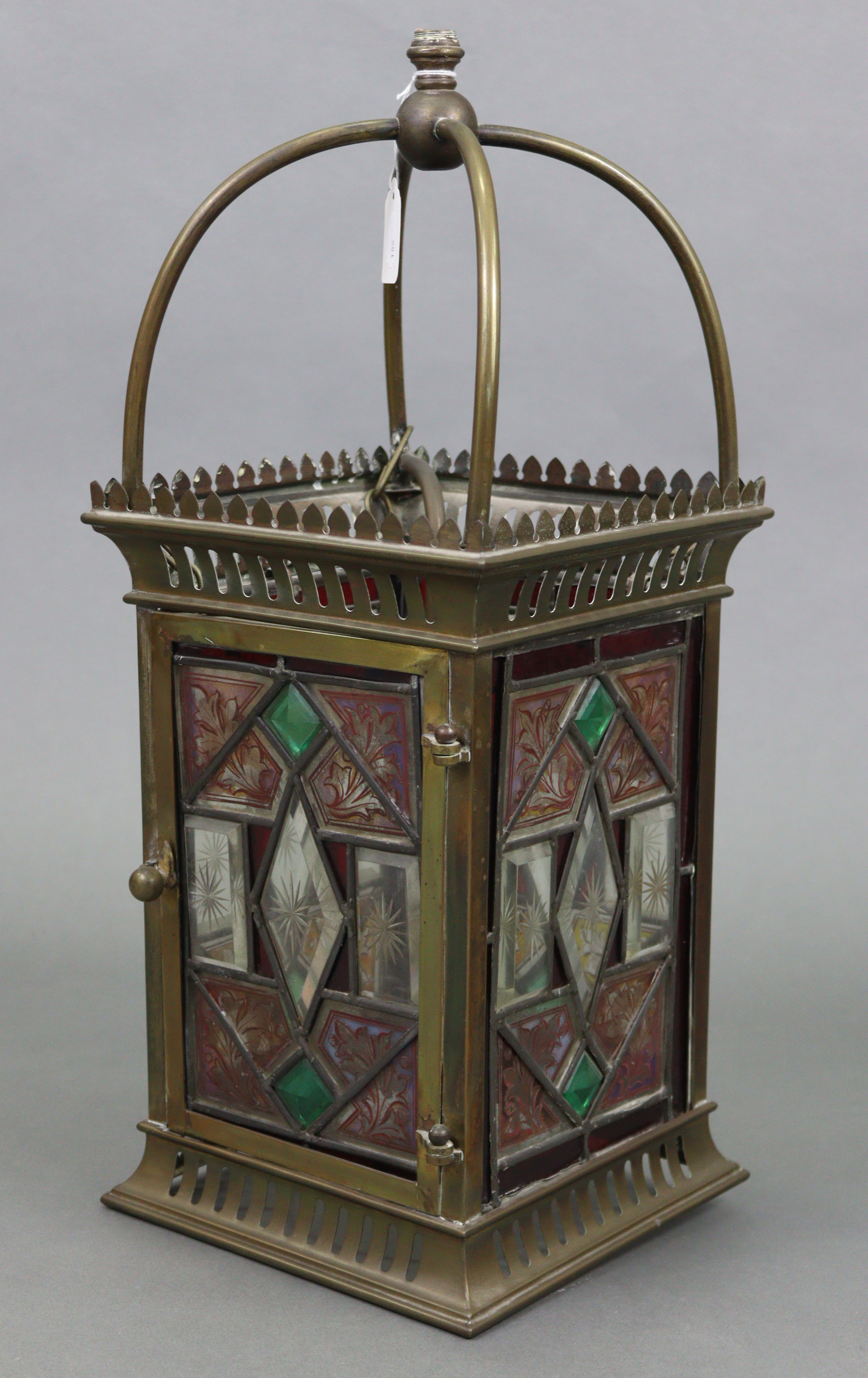An Edwardian brass hall lantern of square form & inset four stained, bevelled, & leaded glazed