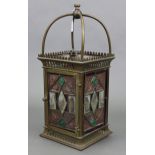An Edwardian brass hall lantern of square form & inset four stained, bevelled, & leaded glazed