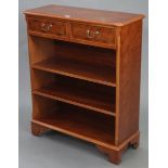 A reproduction yew wood standing bookcase, fitted two frieze drawers above two adjustable shelves, &