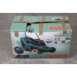 A Bosch “Rotak 34” power driven lawn mower, - as new, boxed.