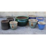 Eight various assorted garden pots.