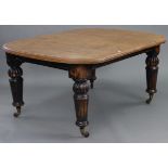 A late 19th century oak extending dining table, with rounded ends & moulded edge to the