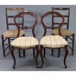 A pair of Victorian-style balloon-back dining chairs with padded seats, & on slender cabriole