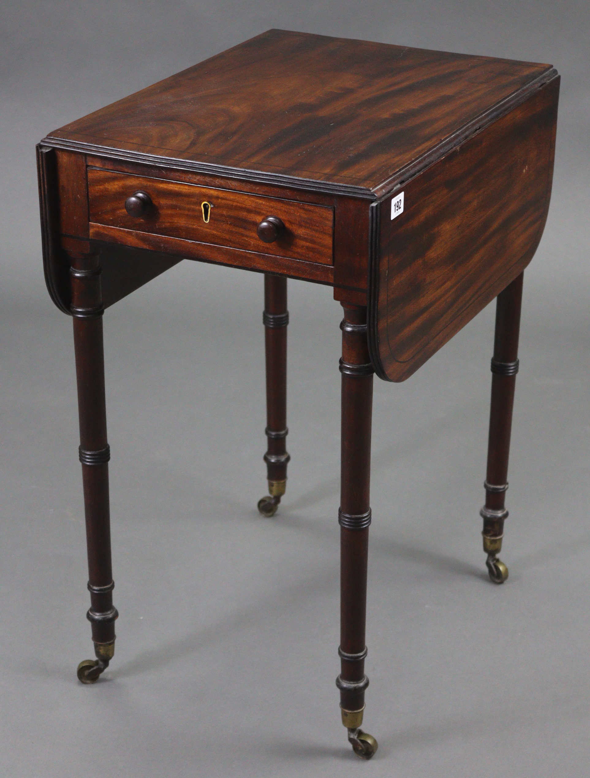 A 19th century inlaid-mahogany rectangular drop-leaf work table, on ring-turned legs with brass