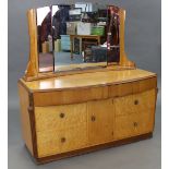 A mid-20th century birds-eye-maple bow-front dressing chest (bears label Tudor Rose), with triple-