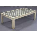 A continental-style cream painted wooden large rectangular coffee table with plate-glass to the
