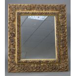 A continental-style gilt frame rectangular wall mirror with raised scroll border, 30¼” x 26¼”.