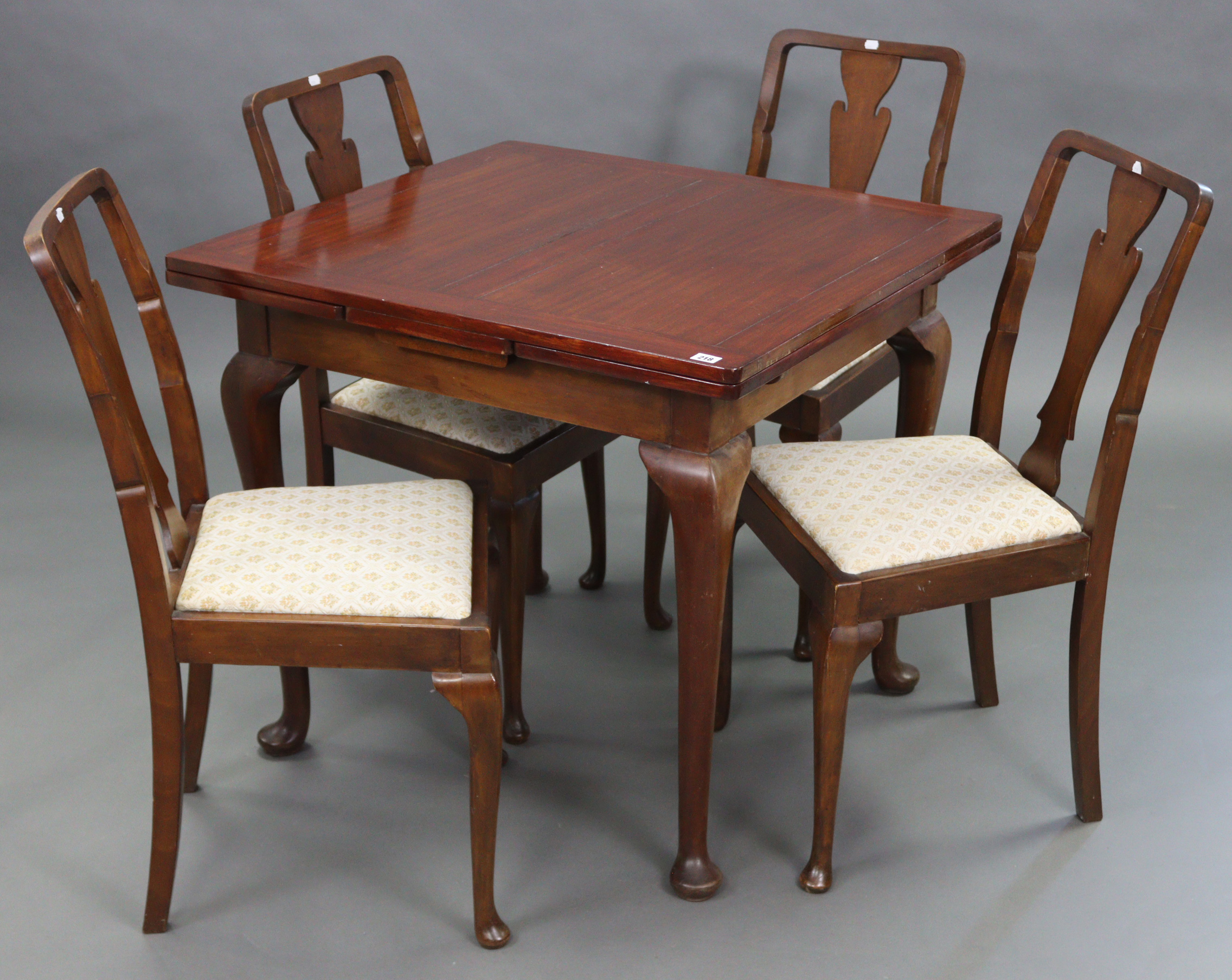 A mahogany draw-leaf dining table on four slender cabriole legs & pad feet, 32” x 57” (open), & a