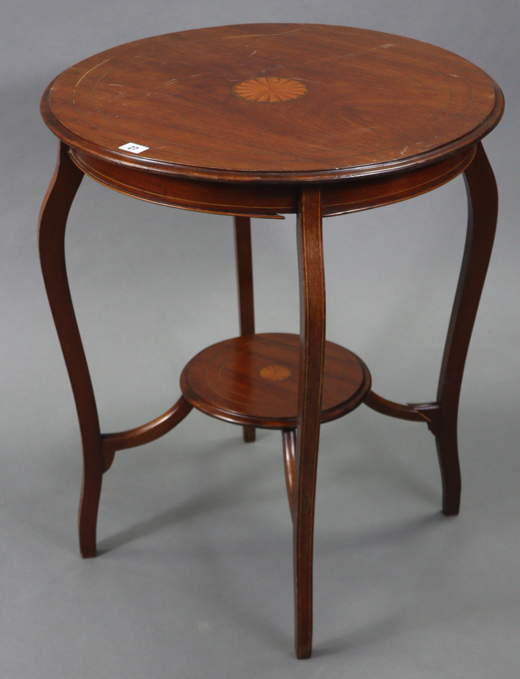 An Edwardian inlaid-mahogany circular two-tier occasional table on four slender cabriole legs, 24”