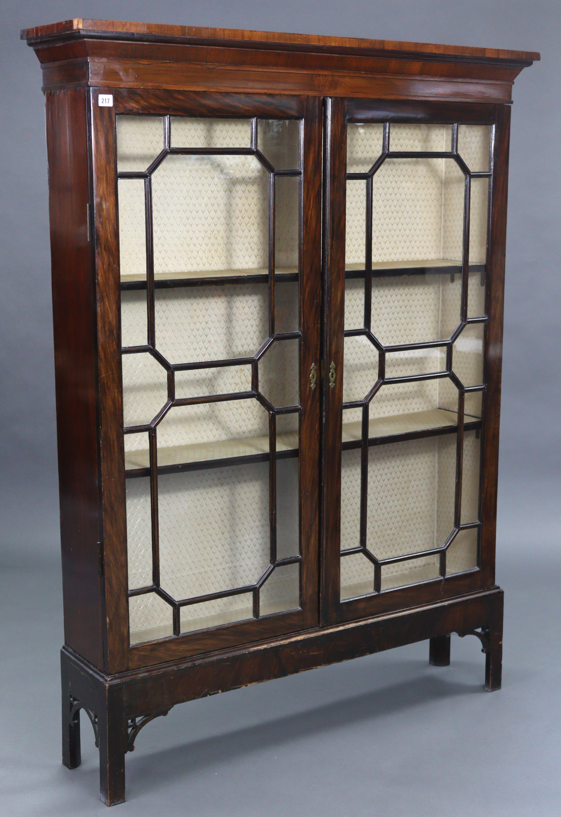A mahogany tall standing bookcase fitted two shelves enclosed by pair of glazed doors, & on short