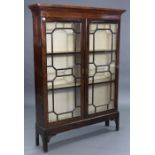 A mahogany tall standing bookcase fitted two shelves enclosed by pair of glazed doors, & on short