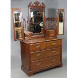 A Victorian walnut dressing chest with three mirrors to the stage back, fitted two short & two