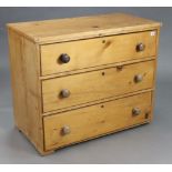 A pine dwarf chest, fitted three long drawers with turned knob handles, 34¾” wide x 28½” high x