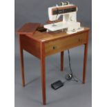 A Singer electric sewing machine (Model No. 5525), in a teak case, on four square legs 28½” wide x