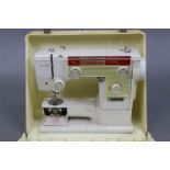 A New Home electric sewing machine with case.