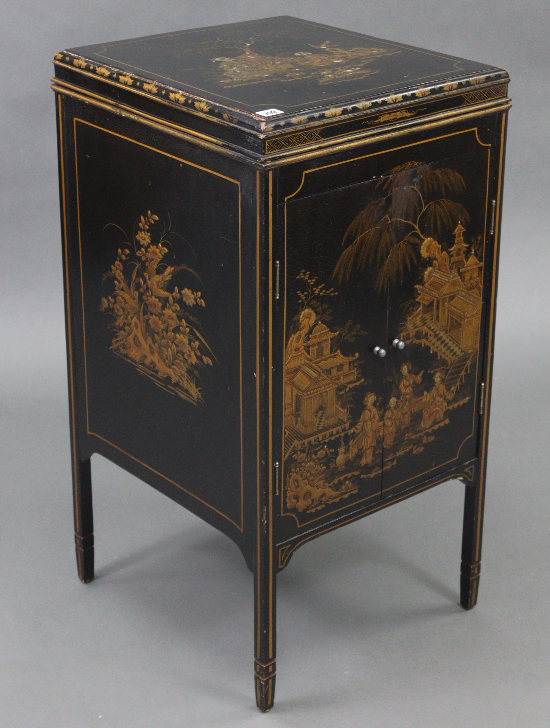 A Chinoiserie-style black lacquered floor-standing gramophone cabinet with gold figure-scene