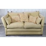 A Knole-style two-seater drop-end settee, with loose cushions to the seat & back upholstered bronzed