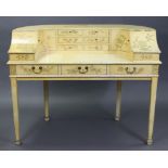 A Carlton House-type cream finish wooden desk, fitted with an arrangement of small drawers &