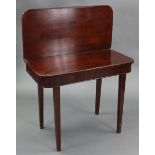 A 19th century mahogany tea table with round front-corners to the rectangular fold-over top, & on