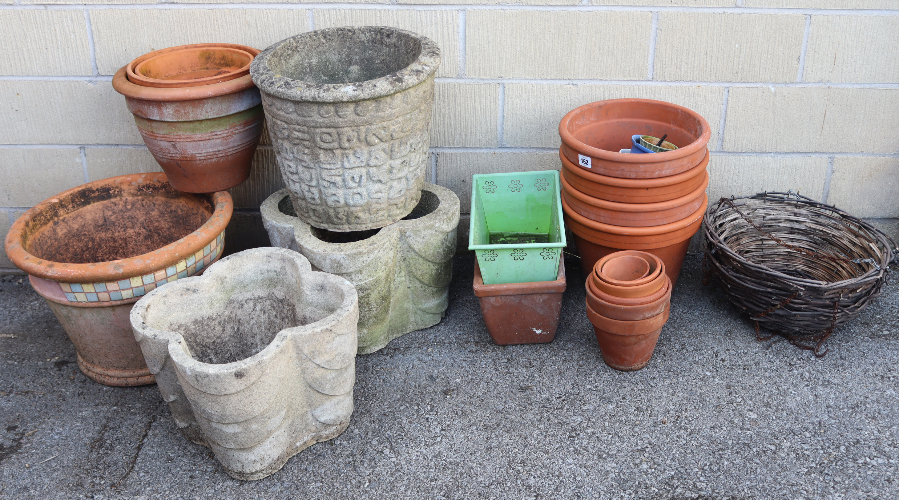 Twenty-two various flower pots & garden troughs; & a pair of wicker hanging baskets.