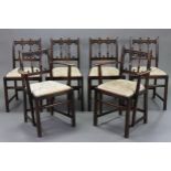 A set of six Ercol oak spindle-back dining chairs (including a pair of carvers) with padded drop-