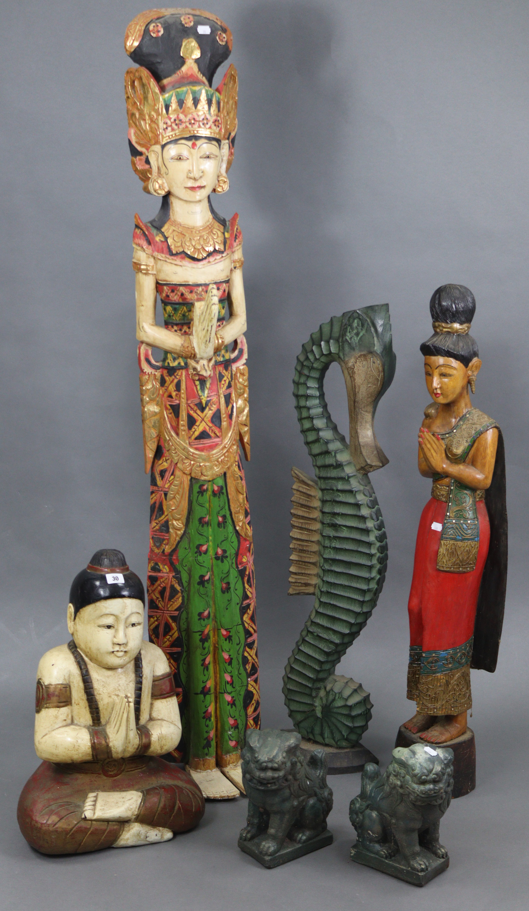 A painted & carved wooden Buddha ornament, 22” high; a pair of temple-dog ornaments, 10” high; &