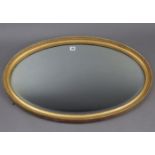 A gilt frame oval wall mirror with beaded edge & inset bevelled plate, 21” x 32½”.