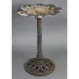 A black-finish metal bird bath with circular top, & on cylindrical centre column & pierced