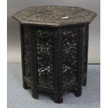 A late 19th/early 20th century eastern hardwood occasional table with carved foliate design to the