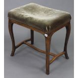 An Edwardian beech piano stool, with padded seat & on slender cabriole legs with plain stretchers,