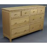 A light oak sideboard, fitted four short drawers above two ranks of two long drawers with turned