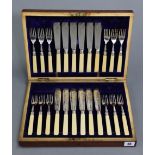 A set of twelve EPNS fish eaters with ivorine handles, & in fitted mahogany case; together with