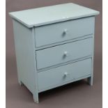 A turquoise painted pine three-drawer bedside chest with turned knob handles, 21” wide x 23” high; &