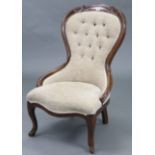 A Victorian-style buttoned-back nursing chair, upholstered cream material & on cabriole legs.