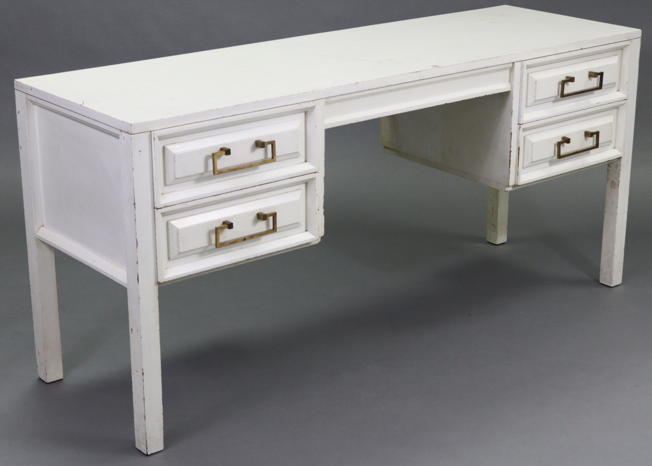 A 1970’s white painted mahogany knee-hole dressing table fitted four drawers, & on square legs,