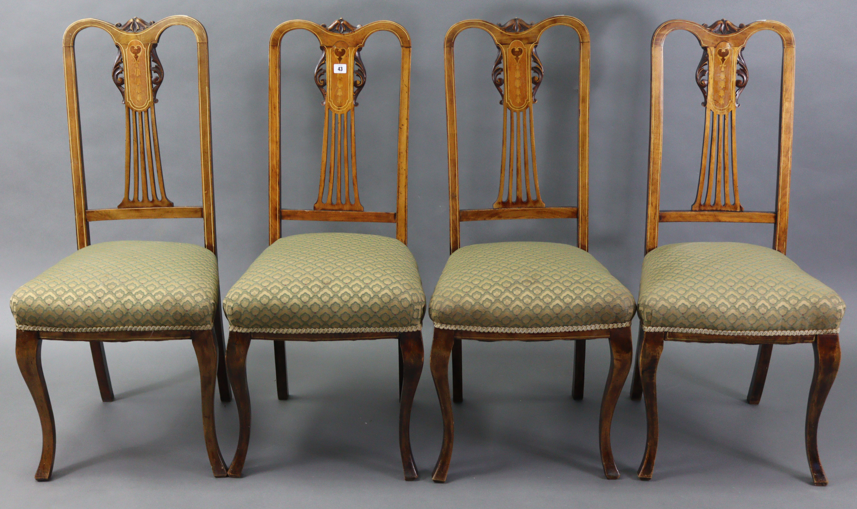 A set of four Edwardian inlaid-beech splat-back dining chairs with padded seats, & on slender