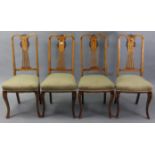 A set of four Edwardian inlaid-beech splat-back dining chairs with padded seats, & on slender