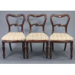A set of three 19th century mahogany dining chairs, each with carved rail to the kidney-shaped
