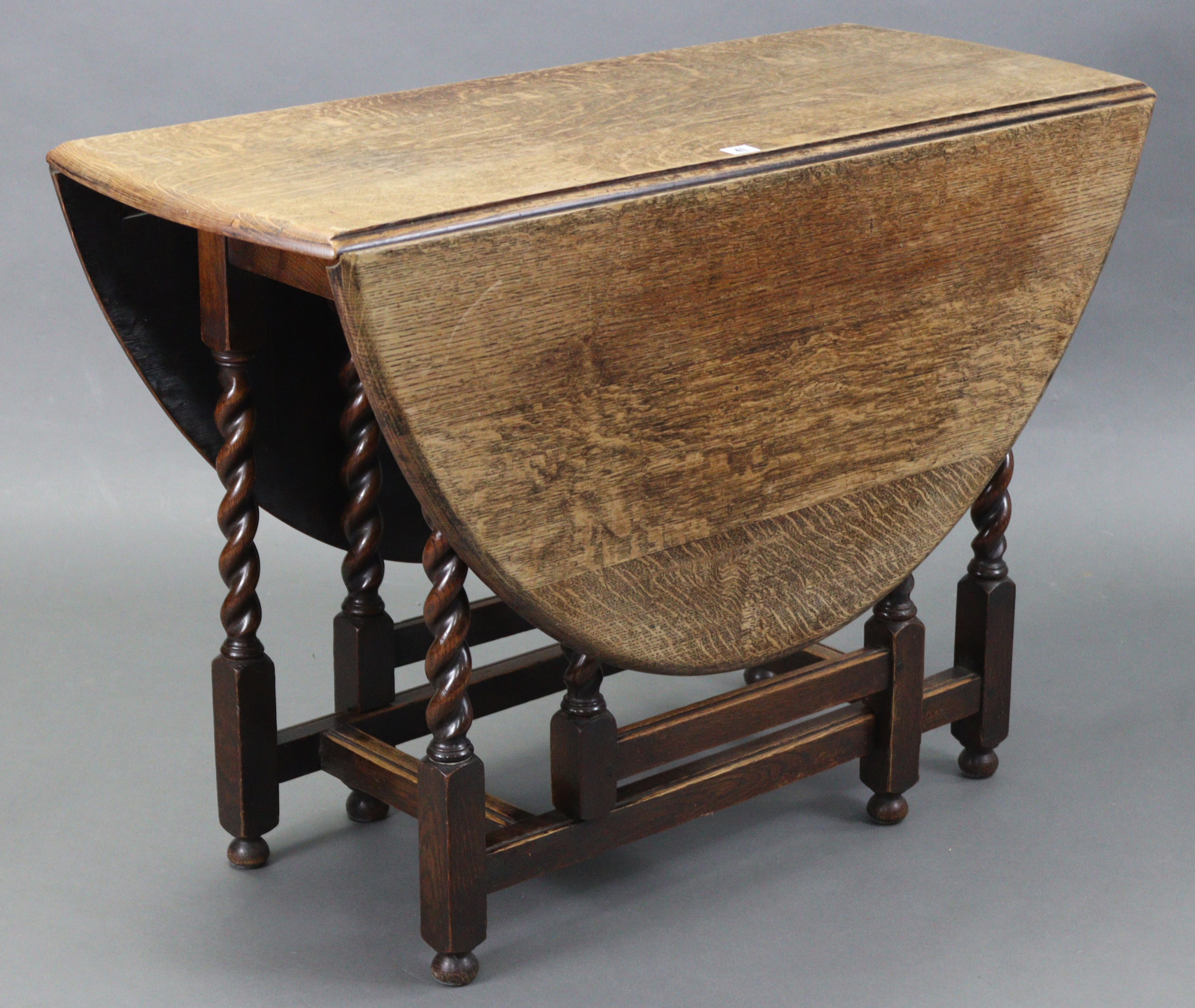 A 1930’s oak oval gate-leg dining table on barley-twist legs & turned feet with plain stretchers, - Image 2 of 3