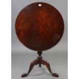 A 19th century-style mahogany tripod table with moulded edge to the circular tilt-top, & on vase-