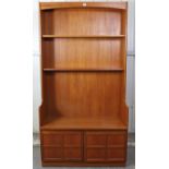 A Nathan teak tall wall unit fitted two shelves above cupboard enclosed by a pair of panel doors,
