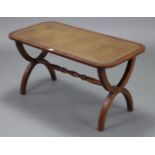 A reproduction mahogany rectangular coffee table on x-shaped end supports joined by a turned