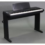 A Yamaha “Type-50” electric piano, with stand, & a small quantity of sheet music.
