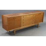 A Younger’s teak sideboard, fitted four long graduated drawers to centre flanked by cupboard to