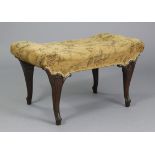 A Victorian mahogany stool, the shaped rectangular seat upholstered floral material, on four foliate