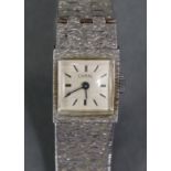 A Caral silver ladies’ bracelet watch with textured surface, the square off-white engine-turned dial